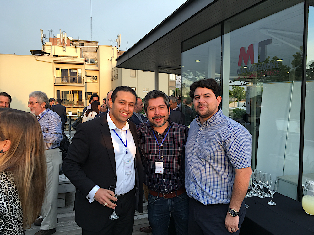 Fady Saad standing with two other people at an MIT social event.