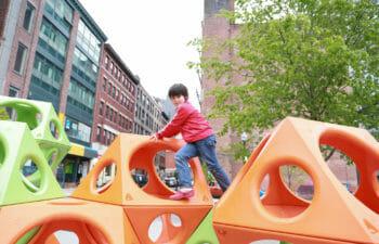 Child climbing on playcubes playground