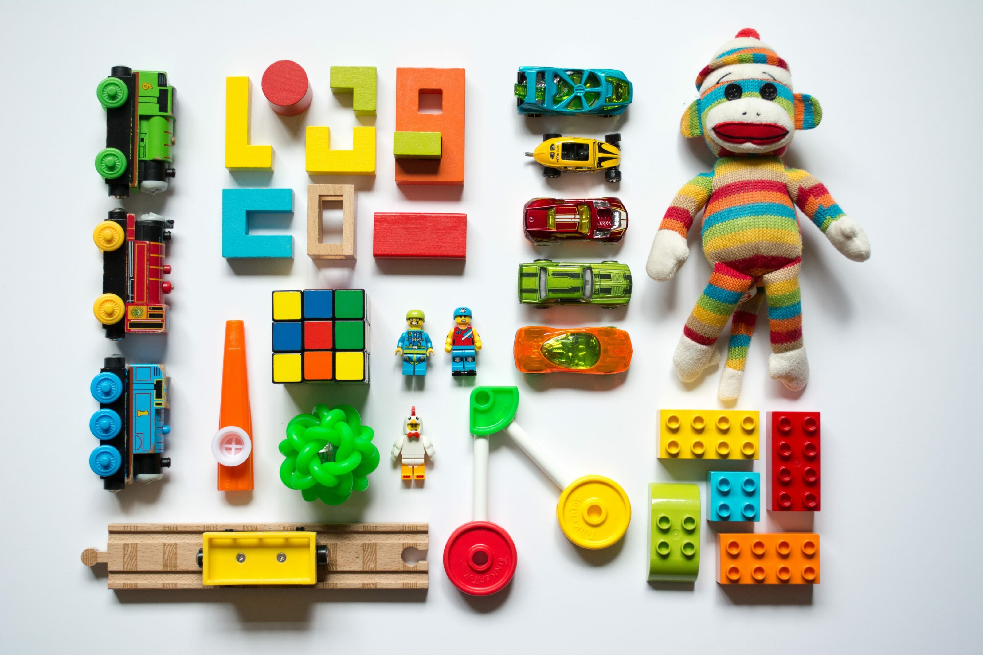 Toys laid out in grid on white background