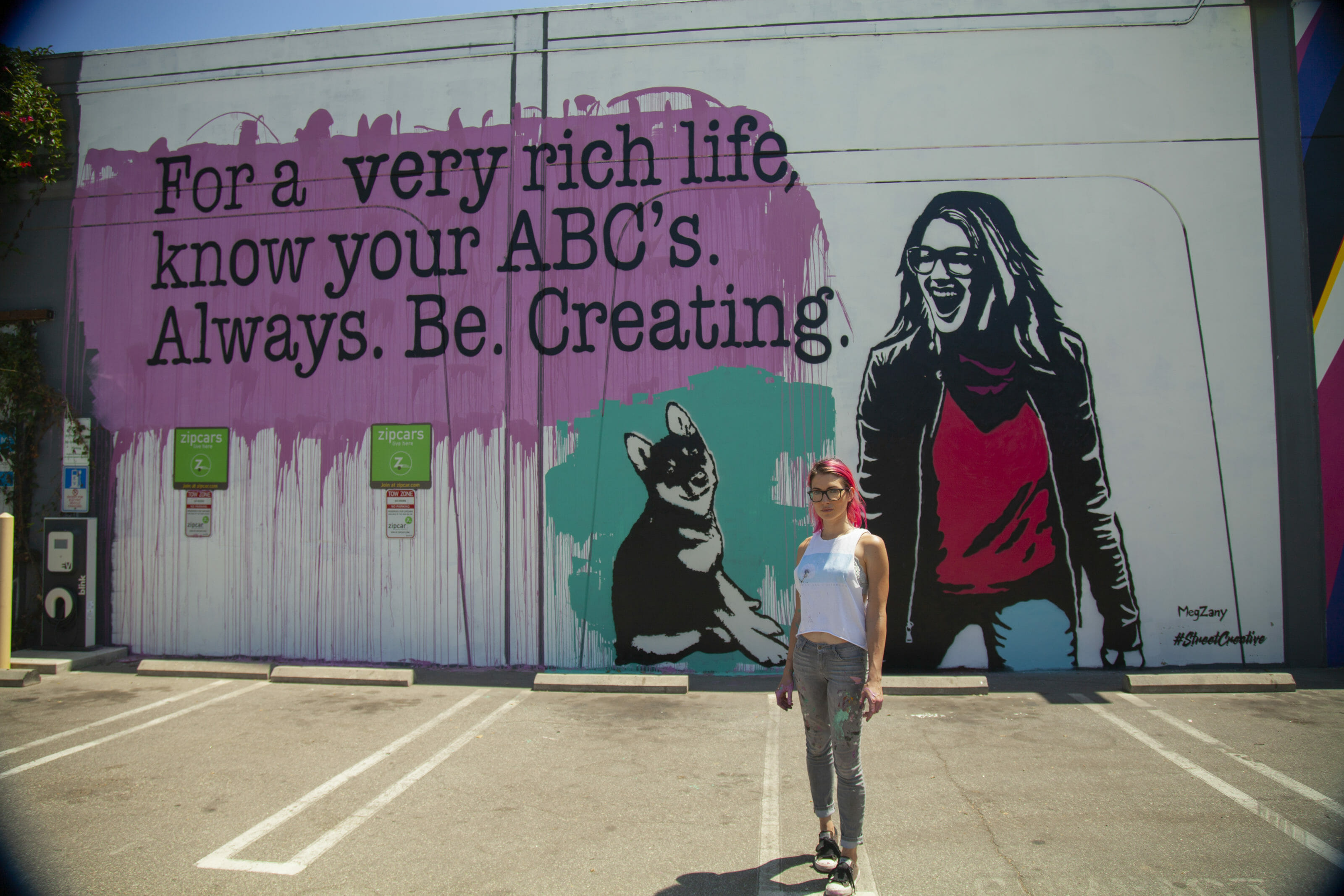 Photo of MegZany in front of her street art.