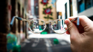 Closeup of glasses looking at a city block