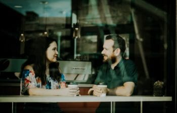 Woman and man talking over coffee