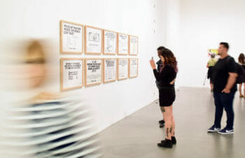People looking at drawings in a gallery space