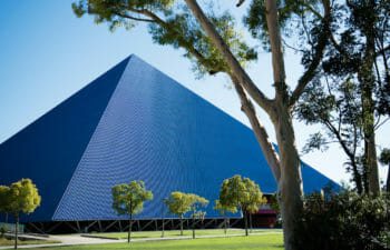 Photo of a glass and metal pyramid on a college campus