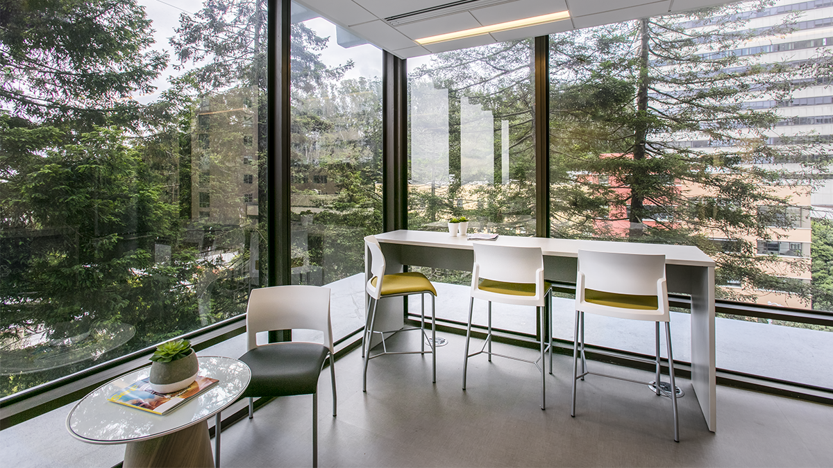 Image from the Common Space Issue of a seating area with a view of a forested landscape.