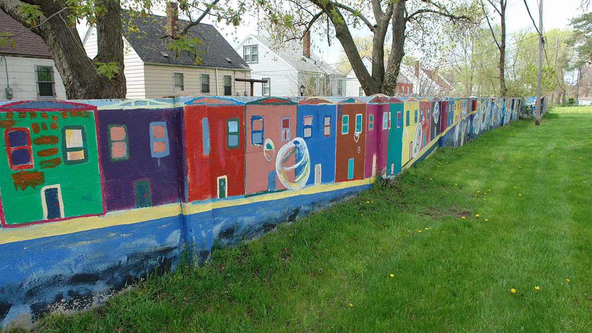 The reimagined Birkwood Wall adjoining Alfonso Wells Memorial Park, painted to symbolize the Black community's history and endurance