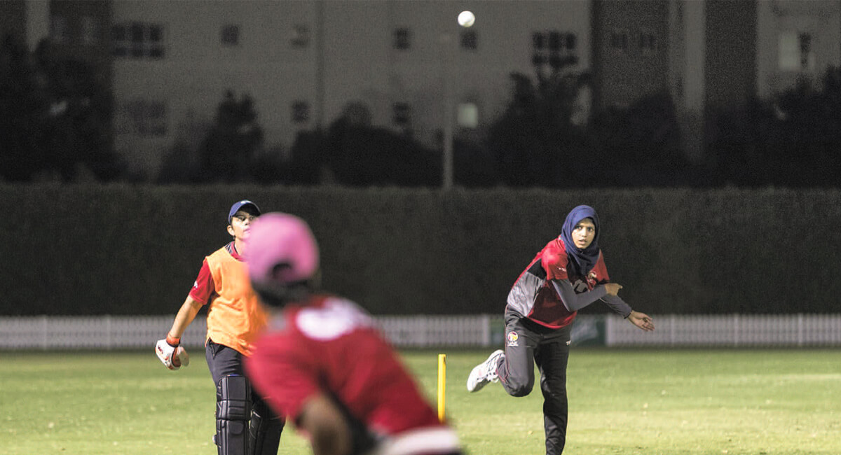 Humaira Tasneem playing cricket with teammates
