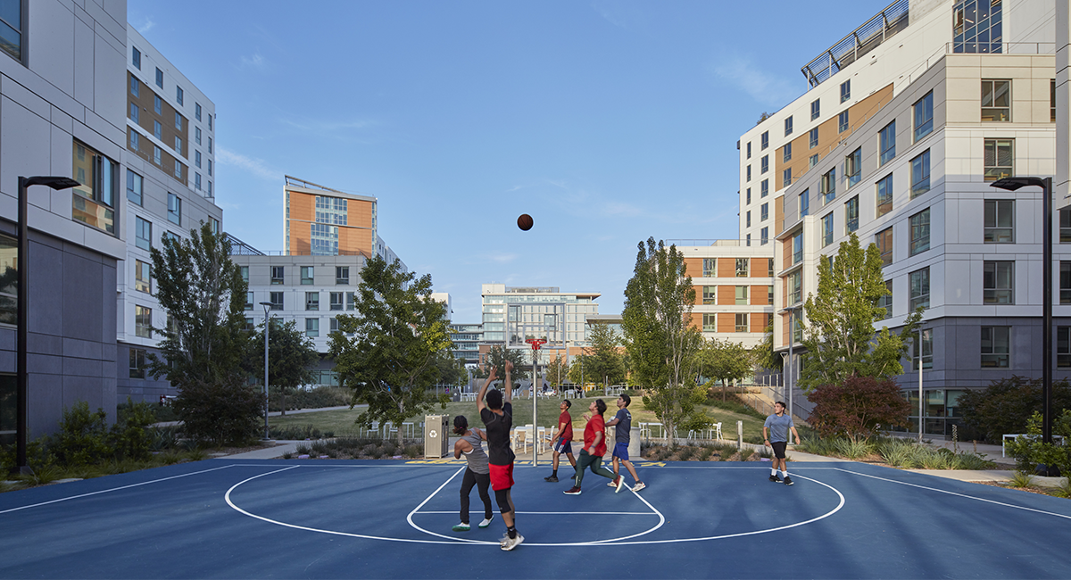 Kids playing basketball in an urban environment