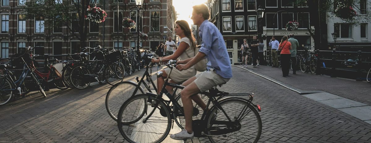 photo of to people on bicycles